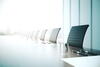 Boardroom table with empty chairs